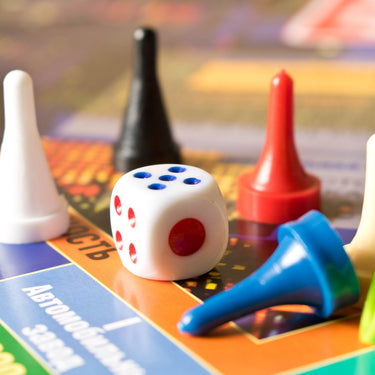 Game pieces sitting on top of a board game.